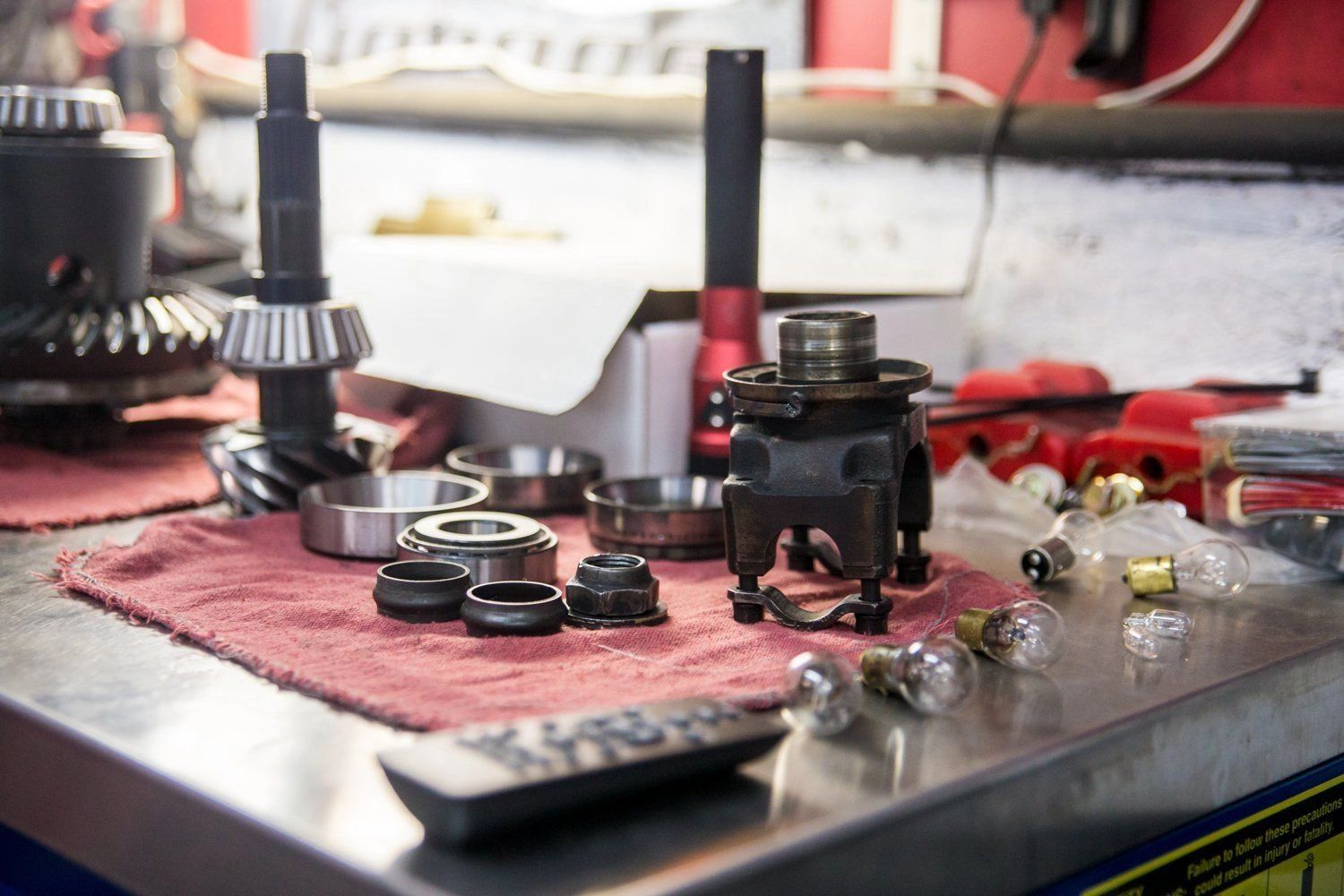 Automotive parts and bearings laid out on workbench at Pro Automotive Repair