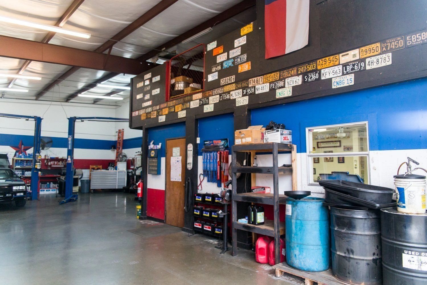 Inside Pro Automotive Repair shop showing work area and Texas flag