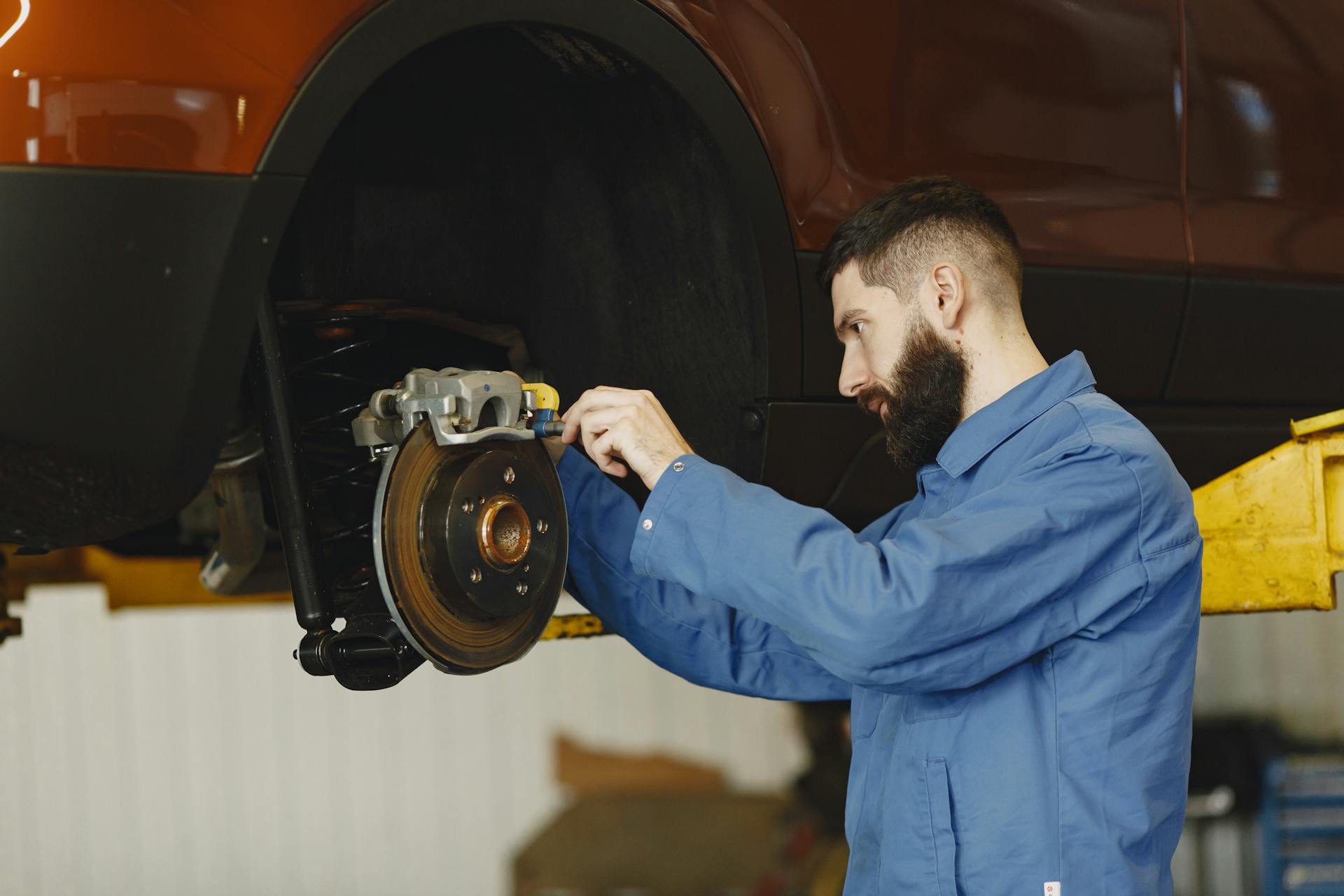 Mechanic performing brake repair service at Pro Automotive Repair in Sachse TX